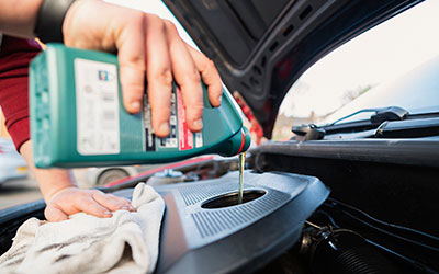 Adding oil to the engine of a car