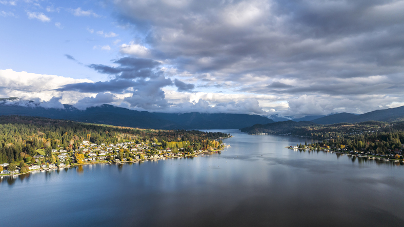 Aerial view of Lake Whatcom surrounded by evergreen trees and residential homes