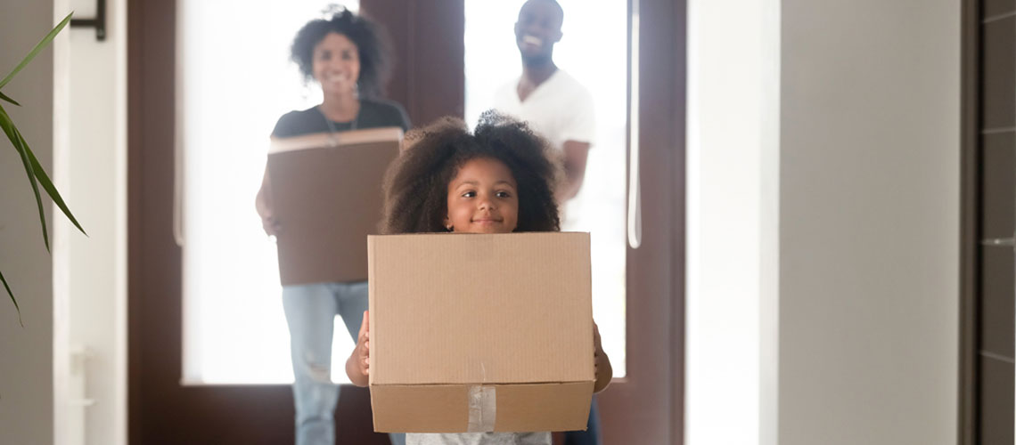 child-with-moving-boxes-1140x500