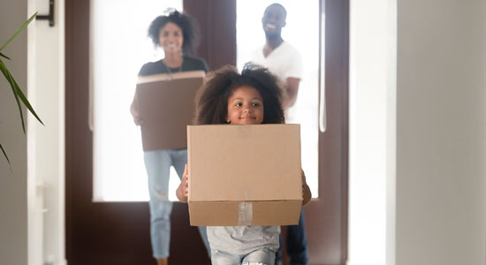 thumbnailfor girl carrying moving boxes in new home