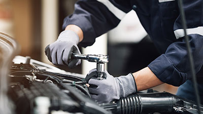 Mechanic working on the engine of a car