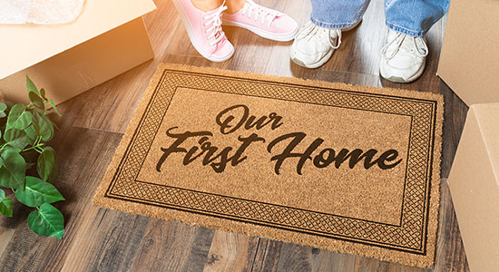 thumbnailfor Couple standing in front of first home welcome mat