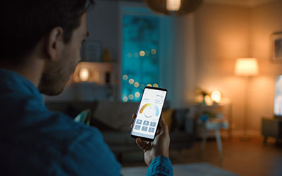 A man controls the smart lights in his home with his phone