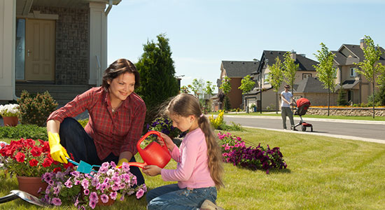 thumbnailfor A woman and young girl plant flowers in their yard