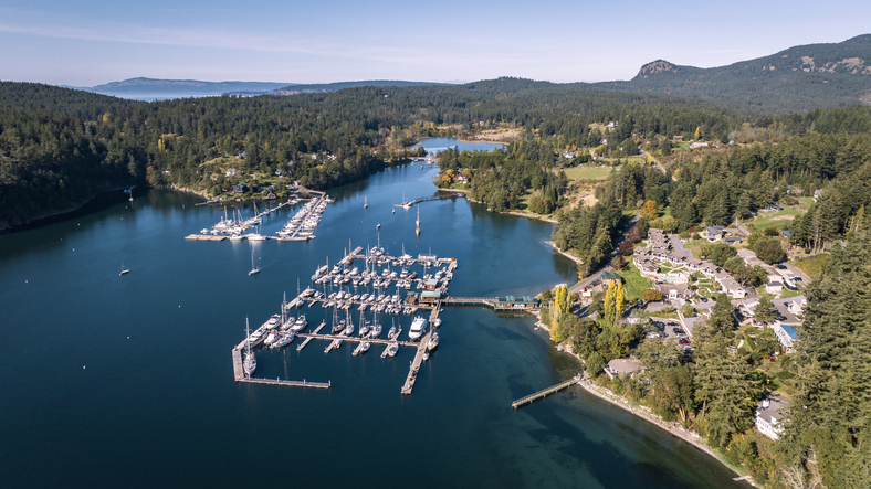 Aerial view of boats docked in Deer Harbor surrounded by forested coastline on Orcas Island