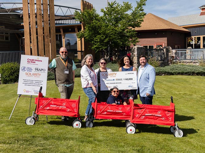 Solarity employees presenting donation to Credit Unions for Kids