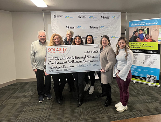 Solarity employees presenting donation to Yakima Habitat for Humanity