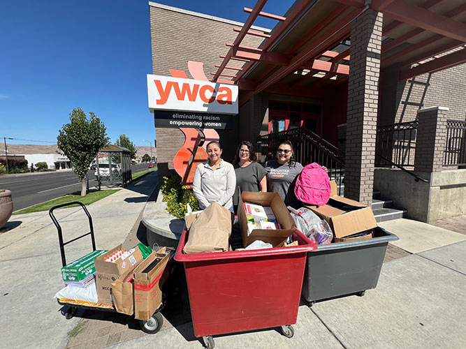 Solarity employees delivering school supplies to YWCA