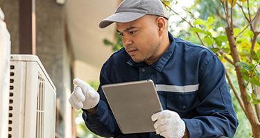 Small business HVAC owner performing maintenance