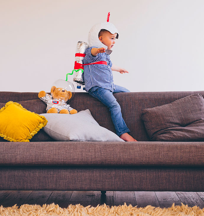 Astronaut Child playing on home couch