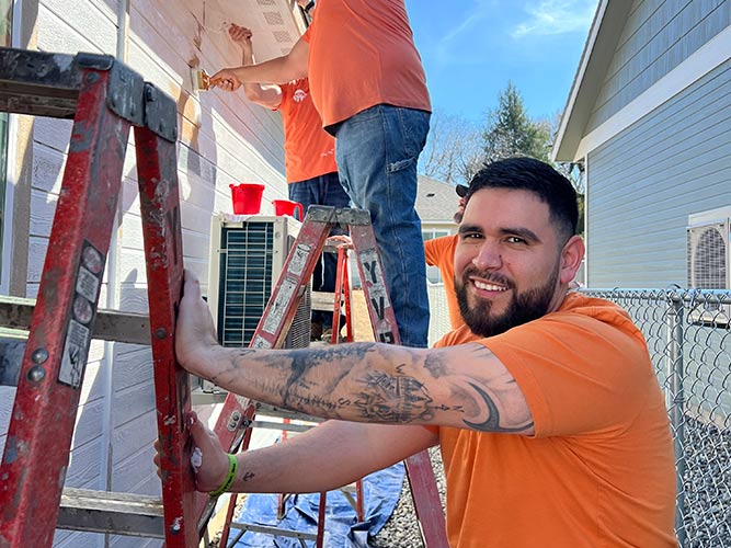 Solarity team painting house at 2025 Yakima Habitate build day